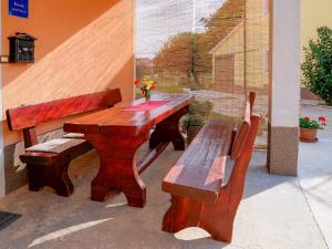 a wooden table and bench next to a window at Apartment Vilma in Vižinada +11 photos