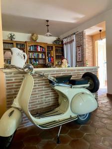 a white scooter parked in a living room at Da Artù in Cittaducale