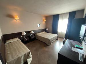 Postel nebo postele na pokoji v ubytování Hotel Le Badie