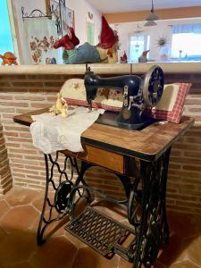 a sewing machine on a table with pillows on it at Da Artù in Cittaducale
