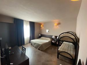 Postel nebo postele na pokoji v ubytování Hotel Le Badie