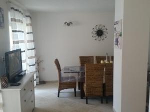 a dining room with a glass table and chairs at Adriatic Queen in Gdinj