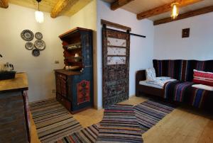 a living room with a wooden door and a couch at Sura din Joseni in Porumbacu de Sus +44 photos