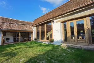an external view of a house with large sliding glass doors at Sura din Joseni in Porumbacu de Sus