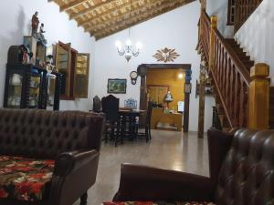 a living room with a couch and a table at Recanto Bom Despacho in Tiradentes