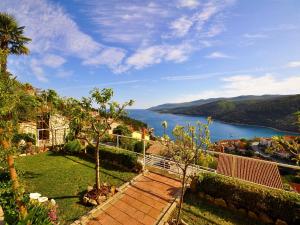 a house with a view of the water at Apartments Paliska in Rabac