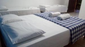 a bed with two towels on top of it at Pousada Dos Girassois Prado in Prado