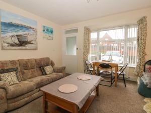 a living room with a couch and a table at Helredale Retreat Whitby in Whitby