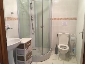 a bathroom with a shower and a toilet and a sink at Le Jardin de Rose 24 FEUILLEBERT Romagne 86700 in Romagne +68 photos