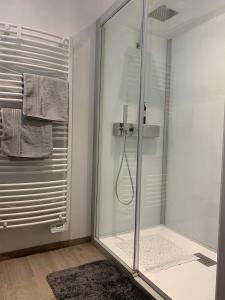 a shower with a glass door in a bathroom at Au petit nid Froissart in Chimay +28 photos