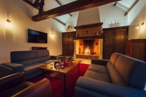 a living room with two couches and a fireplace at Clos Celeste - campagne d Etretat avec piscine et spa in Écrainville