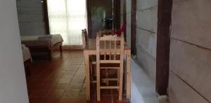 a room with a chair and a table in it at Centro Ecoturistico Ya´ajche in Lacanjá