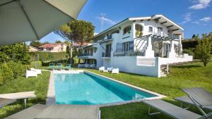 a villa with a swimming pool and a house at Villa Sarah 102 Emma Villas in Riccione