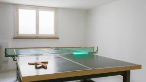 a ping pong table in the middle of a room at Villa Sarah 102 Emma Villas in Riccione