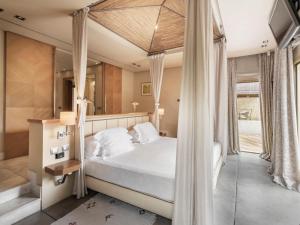 a bedroom with a bed with a canopy at The Villas at Bahia del Duque in Adeje +25 photos