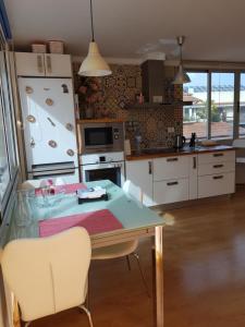 eine Küche mit einem Tisch, Stühlen und einem Kühlschrank in der Unterkunft Apartamento Puerto de la Cruz in Puerto de la Cruz