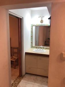 a bathroom with a sink and a mirror at Casa Miradores del Lago in Bialet Massé