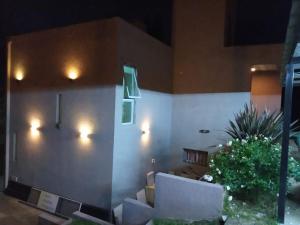 a room with two couches and a wall with lights at Casa Miradores del Lago in Bialet Massé