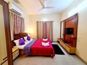 a bedroom with a red bed and a tv at Oreo Villa with Swimming Pool in Mahabaleshwar +96 photos
