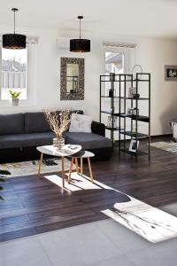 a living room with a couch and a table at A-765 Apartman in Szentgotthárd