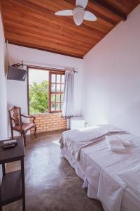 Cama ou camas em um quarto em Pousada Alto do Cajueiro