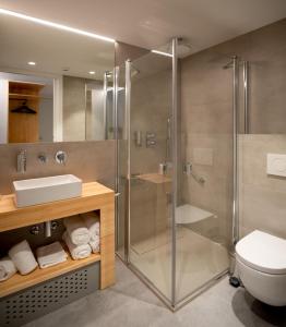 a bathroom with a glass shower and a toilet at Cristina Enea Rooms in San Sebastián