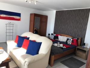 a living room with two chairs and a couch at Leander Apartman Balatonakali in Balatonakali