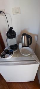 a white refrigerator with a tea pot and a kettle at B&B Casa del Teatro in Mantova