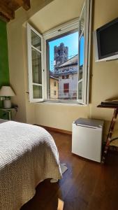 Postel nebo postele na pokoji v ubytování Hotel Piazza Vecchia