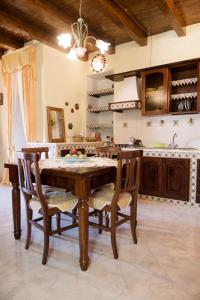 a kitchen with a wooden table and chairs at Sabrina Suite in Milazzo