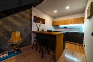 a kitchen with a bar with stools and a lamp at Eco-Lotf Vegueta in Las Palmas de Gran Canaria