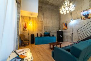 a living room with a blue couch and a table at Eco-Lotf Vegueta in Las Palmas de Gran Canaria