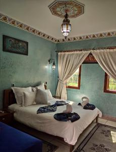 a bedroom with two beds with towels on them at Equi Palace & SPA Near Aeroport in Berrechid
