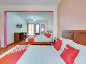 Una cama o camas en una habitación de OYO Hotel Huautla, Oaxaca