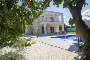 a villa with a swimming pool and a house at Rafaella Beach Villa- Pvt Pool-Near Sea/Beach in Argaka +46 photos