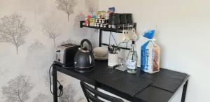 a black table with a tea kettle on it at Stunning Room with Large Private Bathroom in Derby