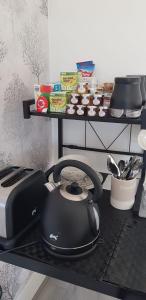 a black tea kettle on a counter in a kitchen at Stunning Room with Large Private Bathroom in Derby