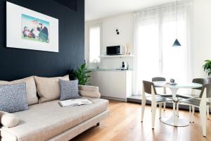 a living room with a couch and a table at BMORE Duomo - Luxury Apartments near Duomo in Milan