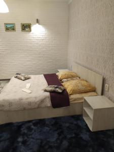 a bedroom with a large bed with a table at Mini Hotel na Leningradke in Kyiv