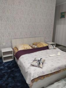 a bedroom with two beds and a wall at Mini Hotel na Leningradke in Kyiv