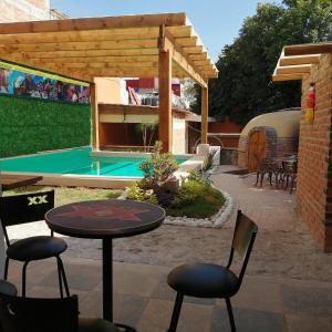 a patio with a table and chairs and a pool at Ex Hacienda Santa Elena in Atlixco