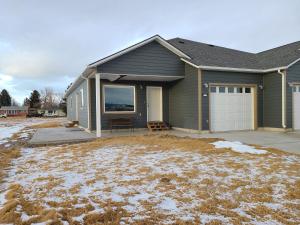 a house with a driveway and a garage at Beaverhead House Rental in Dillon