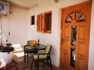 a room with a table and chairs and a wooden door at Apartmani Rita Studio in Novigrad Istria +39 photos