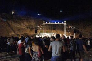 a crowd of people standing around a stage at night at Turismo Rurale La Miniera Fiorita in Arbus