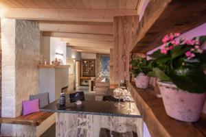 a room with a bar with a vase of flowers at Casa de Fiemme in Tesero