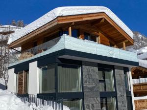 a house with a snow covered roof at Allegra in Samnaun