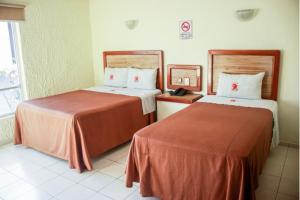 Postel nebo postele na pokoji v ubytování Hotel Gina