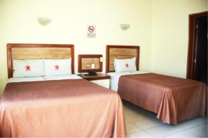 Postel nebo postele na pokoji v ubytování Hotel Gina