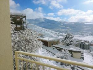 a view from a balcony of a building in the snow at Jasmin Suites in Majdal Shams