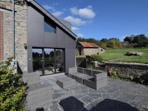 a house with stairs and a stone wall at Charming Holiday Home in Sainte Ode with Terrace in Amberloup